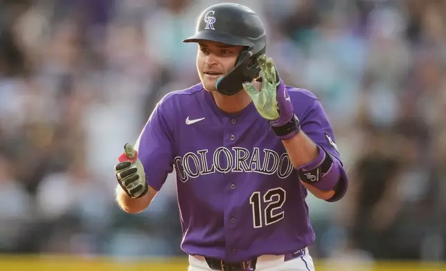 Colorado Rockies' Kyle Karros celebrates after reaching second base on a two-run double off Miami Marlins starting pitcher Sandy Alcantara in the third inning of a baseball game Monday, June 29, 2026, in Denver. (AP Photo/David Zalubowski)