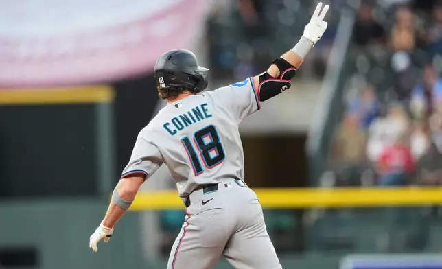 Miami Marlins pinch hitter Griffin Conine gestures to the bullpen as he circles the bases after hitting a three-run home run off Colorado Rockies relief pitcher Victor Vodnik in the fifth inning of a baseball game Monday, June 29, 2026, in Denver. (AP Photo/David Zalubowski)