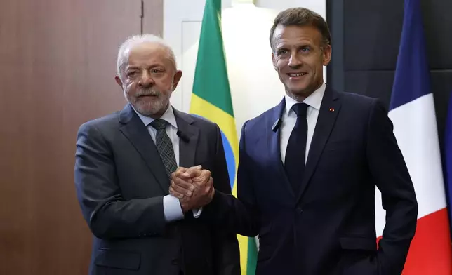 French President Emmanuel Macron and Brazilian President Luiz Inacio Lula da Silva, left, attend a bilateral meeting on the sidelines of the G7 summit in Evian-les-Bains, France, Monday, June 15, 2026. (Yoan Valat, Pool Photo via AP)