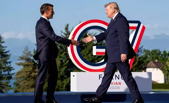 Emmanuel Macron, President of France, left, greets U.S. President Donald Trump during the G7 summit in Evian-les-Bains, France, Monday, June 15, 2026. (Christopher Katsarov/The Canadian Press via AP)