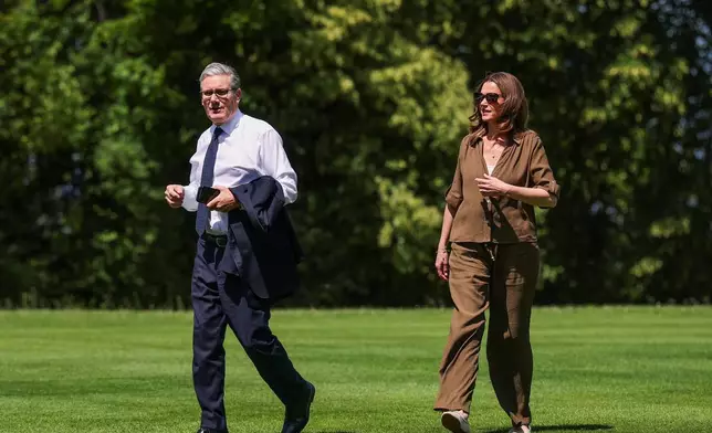 Britain's Prime Minister Keir Starmer arrives with his wife Victoria Starmer ahead of the G7 Summit, held in France's Evian-les-Bains, in Geneva, Switzerland, Monday June 15, 2026. (Isabel Infantes, Pool Photo via AP)