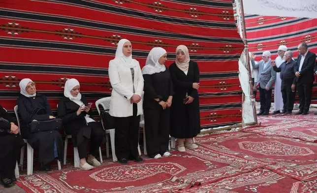 Residents gather to mourn former chess champion Rania al-Abbasi and her family, who disappeared 13 years ago, after relatives announced Monday they had evidence the family was killed by pro-government gunmen in 2013, in Damascus, Syria, Tuesday, June 2, 2026. (AP Photo/Ghaith Alsayed)