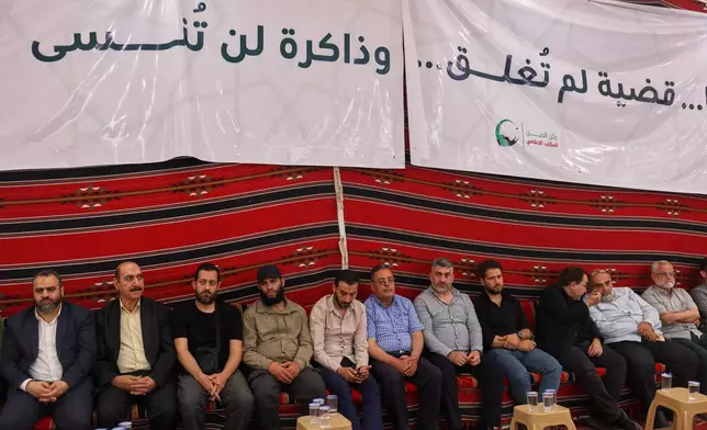Residents gather to mourn former chess champion Rania al-Abbasi and her family, who disappeared 13 years ago, after relatives announced Monday they had evidence the family was killed by pro-government gunmen in 2013, in Damascus, Syria, Tuesday, June 2, 2026. (AP Photo/Ghaith Alsayed)