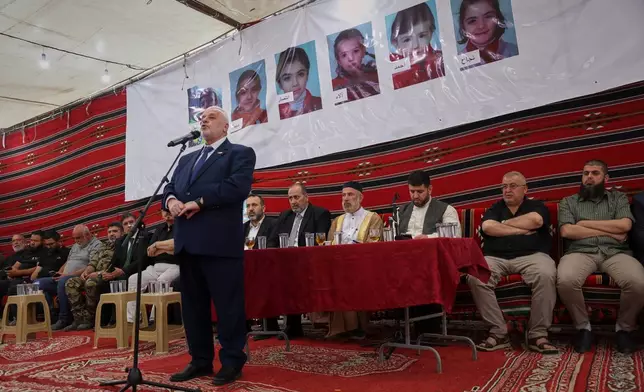 Mohammad Shukri, Syrian minister of religious affairs, speaks during a gathering to mourn former chess champion Rania al-Abbasi and her family, who disappeared 13 years ago, after relatives announced Monday they had evidence the family was killed by pro-government gunmen in 2013, in Damascus, Syria, Tuesday, June 2, 2026. (AP Photo/Ghaith Alsayed)