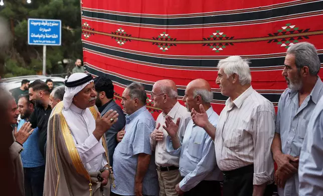 Residents gather to mourn former chess champion Rania al-Abbasi and her family, who disappeared 13 years ago, after relatives announced Monday they had evidence the family was killed by pro-government gunmen in 2013, in Damascus, Syria, Tuesday, June 2, 2026. (AP Photo/Ghaith Alsayed)