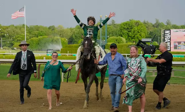 Jockey Jose Ortiz celebrates aboard Golden Tempo as they are led to the winner's circle after winning the 158th running of the Belmont Stakes horse race, Saturday, June 6, 2026, in Saratoga Springs, N.Y. (AP Photo/Yuki Iwamura)