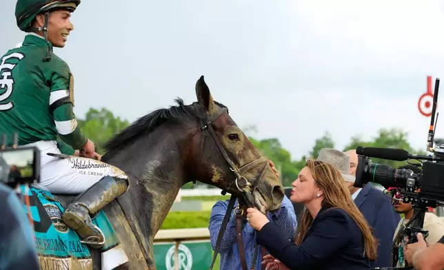 Trainer Cherie DeVaux, right, greet Golden Tempo (9) and Jockey Jose Ortiz after they won the 158th running of the Belmont Stakes horse race, Saturday, June 6, 2026, in Saratoga Springs, N.Y. (AP Photo/Yuki Iwamura)