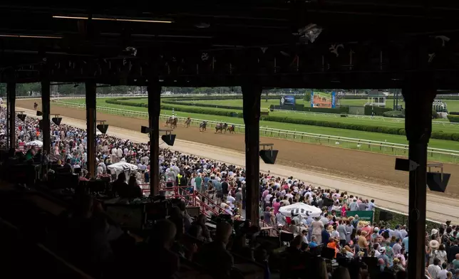 Spectators watch the second race of the day before the 158th running of the Belmont Stakes horse race at Saratoga Race Course, Saturday, June 6, 2026, in Saratoga Springs, N.Y. (AP Photo/Yuki Iwamura)