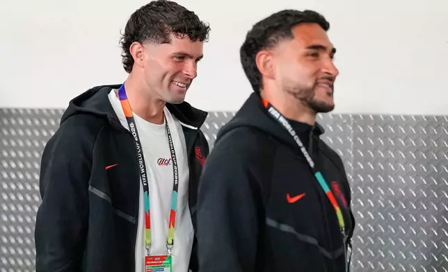 United States' Christian Pulisic, left, and teammate Cristian Roldan arrive at the stadium ahead of the World Cup Group D soccer match between Turkey and the United States in Inglewood, Calif., near Los Angeles, Thursday, June 25, 2026. (AP Photo/Gregory Bull)