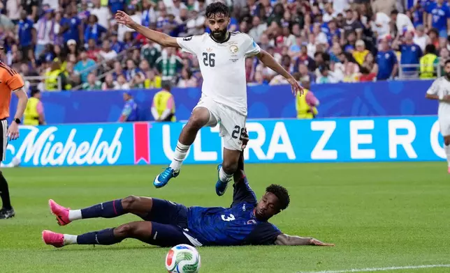 Cape Verde's Diney Borges (3) slides under Saudi Arabia's Mohammed Abu Alshamat (26) during the second half of the World Cup Group H soccer match between Cape Verde and Saudi Arabia in Houston, Friday, June 26, 2026. (AP Photo/David J. Phillip)