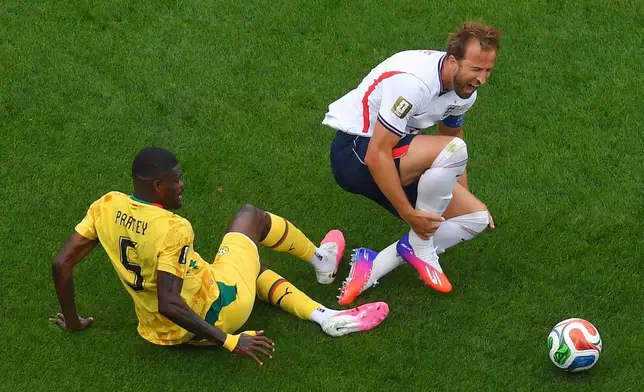 Ghana's Thomas Partey (5) trips up England's Harry Kane, right, during the second half of a World Cup Group L soccer match in Foxborough, Mass., near Boston, Tuesday, June 23, 2026. (AP Photo/Steven Senne)