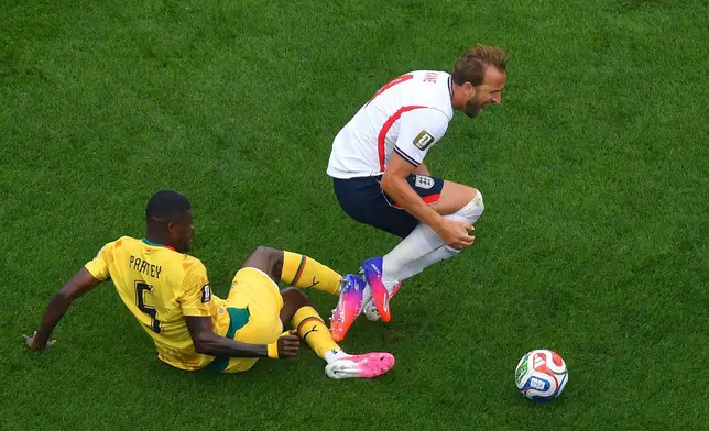 Ghana's Thomas Partey (5) trips up England's Harry Kane, right, during the second half of a World Cup Group L soccer match in Foxborough, Mass., near Boston, Tuesday, June 23, 2026. (AP Photo/Steven Senne)