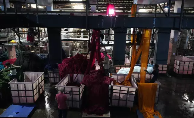 Ventilation systems dispense cool air across a factory from the ceiling at Vinit Fabrics in Palsana near Surat, India, Tuesday, May 26, 2026. (AP Photo/Ajit Solanki)