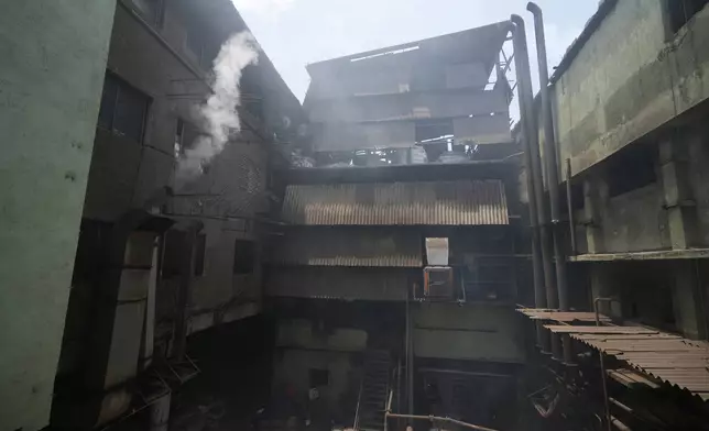 Steam comes out of a textile factory on a hot day in Sachin near Surat, India, Wednesday, May 27, 2026. (AP Photo/Ajit Solanki)