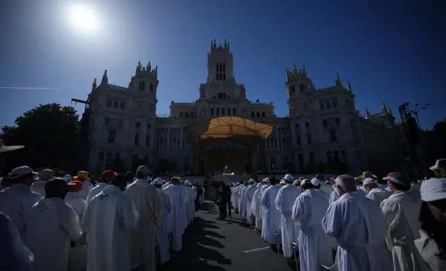 Clergymen wait for Pope Leo XIV to arrive to preside over Mass marking the feast of Corpus Christi in Plaza de Cibeles in Madrid, Sunday, June 7, 2026, on the second day of his seven-day apostolic journey to mainland Spain and the Canary Islands. (AP Photo/Alessandra Tarantino)