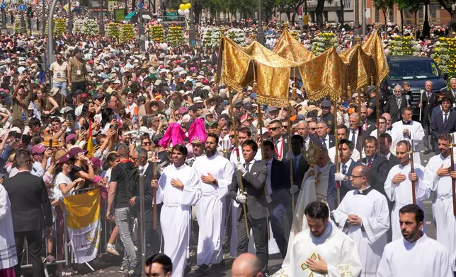 Pope Leo XIV takes part in a procession marking the Catholic feast of Corpus Christi at Plaza de Cibeles in Madrid, Spain, Sunday, June 7, 2026, on the second day of his seven-day apostolic visit to mainland Spain and the Canary Islands. (AP Photo/Bernat Armangue)