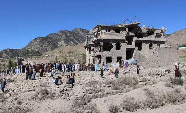 Residents walk through the rubble after what Taliban officials said were Pakistani airstrikes a day earlier that killed civilians, including children, in the village of Mandokhail, Chamkani district, Paktia province, Afghanistan, Monday, June 29, 2026. (AP Photo/Saifullah Zahir)