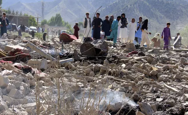 Residents walk through the rubble after what Taliban officials said were Pakistani airstrikes a day earlier that killed civilians, including children, in the village of Mandokhail, Chamkani district, Paktia province, Afghanistan, Monday, June 29, 2026. (AP Photo/Saifullah Zahir)