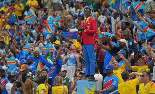 Congo supporter Michel Nkuka Mboladinga, poses as a statue of the country's assassinated independence hero Patrice Lumumba, reacts before the World Cup Group K soccer match between Colombia and Congo in Zapopan, near Guadalajara, Mexico, Tuesday, June 23, 2026. (AP Photo/Fernando Llano)