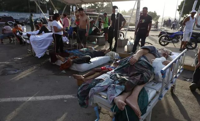 Patients lie outside a hospital evacuated after it was damaged in an earthquake in Catia La Mar, Venezuela, Thursday, June 25, 2026. (AP Photo/Pedro Mattey)