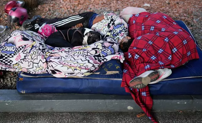 People sleep in the streets a day after an earthquake and several aftershocks struck Caracas, Venezuela, Thursday, June 25, 2026. (AP Photo/Ariana Cubillos)