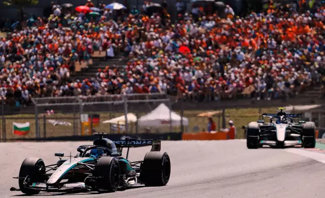 Mercedes drivers George Russell, left, of Britain and Andrea Kimi Antonelli of Italy steer their cars during the Spain F1 Grand Prix race at the Barcelona Catalunya racetrack in Montmelo, near Barcelona, Spain, Sunday, June 14, 2026. (AP Photo/Joan Monfort)