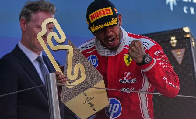 Ferrari driver Lewis Hamilton of Britain celebrates after wining the Spain F1 Grand Prix race at the Barcelona Catalunya racetrack in Montmelo, near Barcelona, Spain, Sunday, June 14, 2026. (AP Photo/Fatima Shbair)
