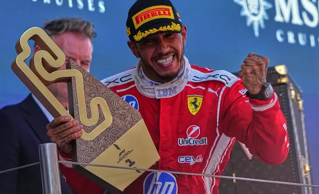 Ferrari driver Lewis Hamilton of Britain celebrates after wining the Spain F1 Grand Prix race at the Barcelona Catalunya racetrack in Montmelo, near Barcelona, Spain, Sunday, June 14, 2026. (AP Photo/Fatima Shbair)