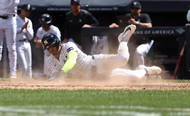New York Yankees' José Caballero slides to score on a single hit by Paul Goldschmidt during the fifth inning of a baseball game against the Boston Red Sox, Sunday, June 7, 2026, in New York. (AP Photo/Pamela Smith)