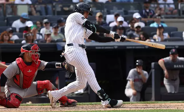 New York Yankees' Cody Bellinger, right, hits a home run during the eighth inning of a baseball game against the Boston Red Sox, Sunday, June 7, 2026, in New York. (AP Photo/Pamela Smith)