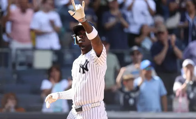 New York Yankees' Jazz Chisholm Jr. reacts after hitting a three-run home run, leading Trent Grisham and Anthony Volpe to also score, during the eighth inning of a baseball game against the Boston Red Sox, Sunday, June 7, 2026, in New York. (AP Photo/Pamela Smith)