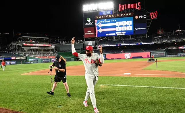 Philadelphia Phillies' Derek Hill gestures to the crowd after a baseball game against the Washington Nationals, Wednesday, June 24, 2026, in Washington. (AP Photo/Nick Wass)