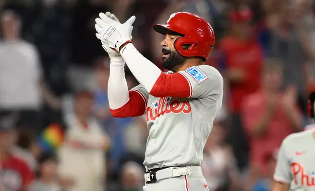 Philadelphia Phillies' Derek Hill celebrates his two-run home run during the ninth inning of a baseball game against the Washington Nationals, Wednesday, June 24, 2026, in Washington. (AP Photo/Nick Wass)
