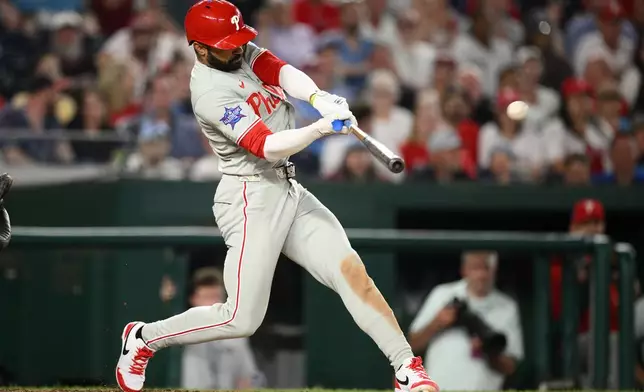 Philadelphia Phillies' Derek Hill hits a two-run home run during the ninth inning of a baseball game against the Washington Nationals, Thursday, June 25, 2026, in Washington. (AP Photo/Nick Wass)