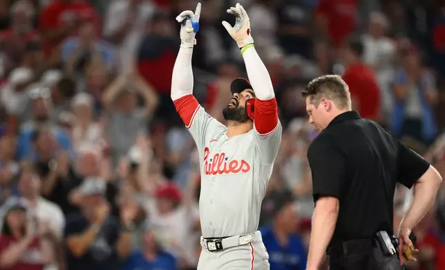 Philadelphia Phillies' Derek Hill celebrates his two-run home run during the ninth inning of a baseball game against the Washington Nationals, Thursday, June 25, 2026, in Washington. (AP Photo/Nick Wass)