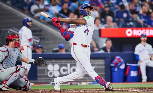 Toronto Blue Jays' Jesus Sanchez hits a home run during the sixth inning of a baseball game against the Philadelphia Phillies, in Toronto, on Tuesday, June 9, 2026. (Sammy Kogan/The Canadian Press via AP)