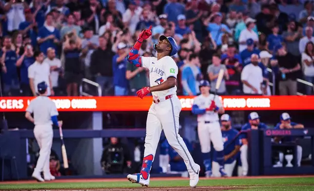Toronto Blue Jays' Jesus Sanchez (12) celebrates after hitting a home run during the sixth inning of a baseball game against the Philadelphia Phillies, in Toronto, on Tuesday, June 9, 2026. (Sammy Kogan/The Canadian Press via AP)