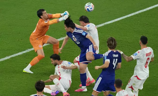 Tunisia goalkeeper Aymen Dahmen blocks a charge by Japan's Ayase Ueda during a World Cup Group F soccer match in Guadalupe, near Monterrey, Mexico, Saturday, June 20, 2026. (AP Photo/Moises Castillo)