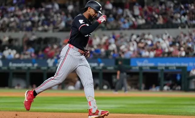 Minnesota Twins' Byron Buxton rounds the bases after hitting a solo home run in the sixth inning of a baseball game against the Texas Rangers in Arlington, Texas, Monday, June 15, 2026. (AP Photo/Tony Gutierrez)