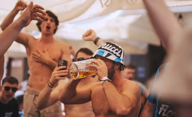 FILE - An Inter fan drinks a beer in the city center ahead of the Champions League final soccer match between Paris Saint-Germain and Inter Milan in Munich, Germany, May 31, 2025. (AP Photo/Markus Schreiber, File)