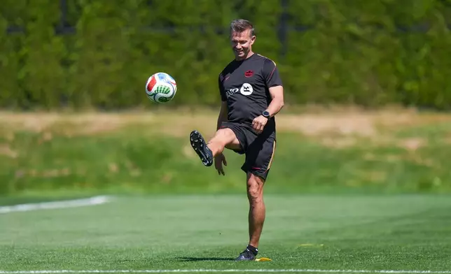 Canada head coach Jesse Marsch kicks a ball before a FIFA World Cup soccer training session, in Vancouver, British Columbia, Tuesday, June 16, 2026. (Darryl Dyck/The Canadian Press via AP)