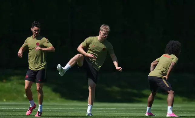 Canada's Stephen Eustaquio, left, and Luc de Fougerolles, middle, work out during a training session on the eve of the team's FIFA World Cup soccer match against Qatar, Wednesday, June 17, 2026, in Vancouver, British Columbia. (AP Photo/Abbie Parr)