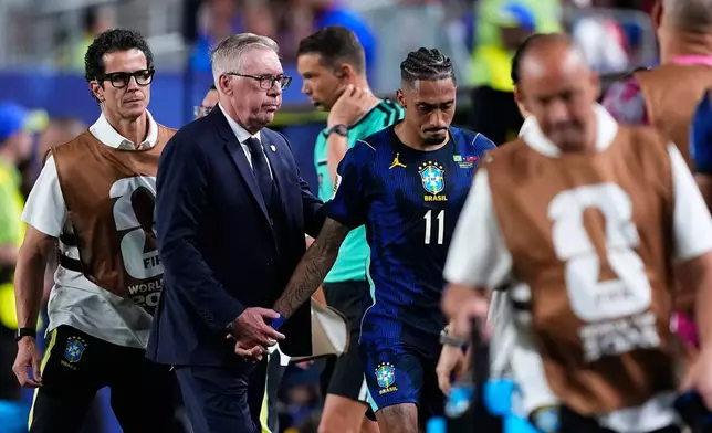 Brazil's Raphinha (11) is comforted by Brazil head coach Carlo Ancelotti during the World Cup Group C soccer match between Brazil and Haiti in Philadelphia, Friday, June 19, 2026. (AP Photo/Petr David Josek)