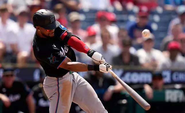 Miami Marlins' Otto Lopez hits an RBI-sacrifice fly against Philadelphia Phillies pitcher Tanner Banks during the sixth inning of a baseball game Wednesday, June 17, 2026, in Philadelphia. (AP Photo/Matt Slocum)