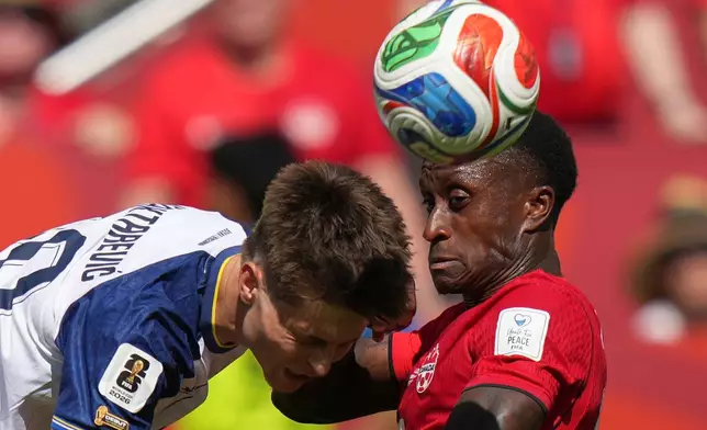Bosnia's Esmir Bajraktarevic, left vies for the ball with Canada's Richie Laryea during the World Cup Group B soccer match between Canada and Bosnia in Toronto, Friday, June 12, 2026. (AP Photo/Stephanie Scarbrough)