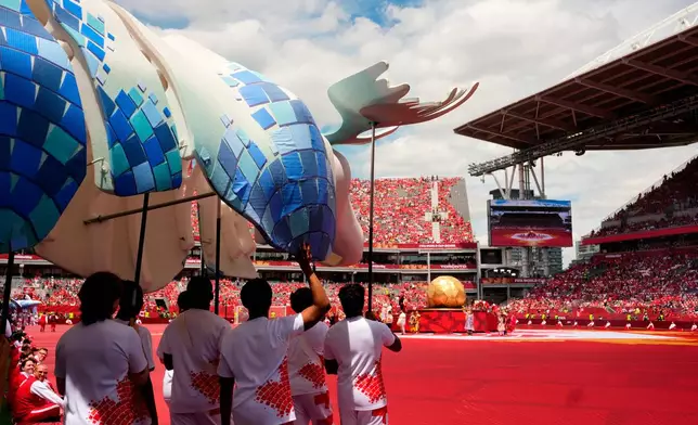 Participants carry a moose puppet during the opening ceremonies before the World Cup Group B soccer match between Canada and Bosnia, Friday, June 12, 2026, in Toronto. (Chris Young/The Canadian Press via AP)