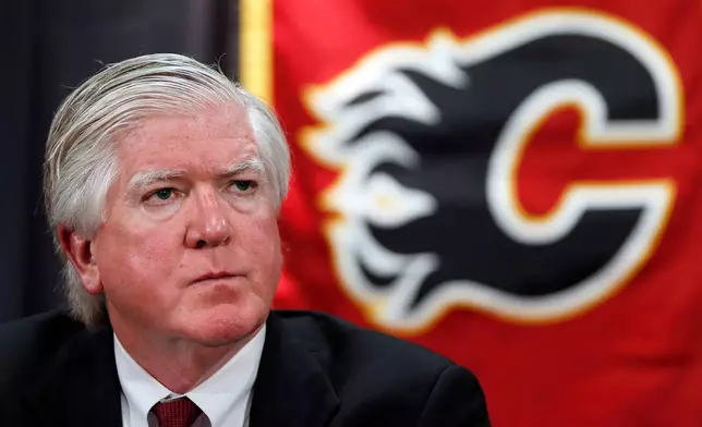 FILE - New Calgary Flames President of Hockey Operations Brian Burke listens to a question during a news conference in Calgary, Alberta, Sept. 5, 2013. (Jeff McIntosh/The Canadian Press via AP)