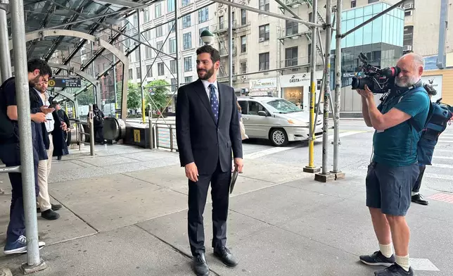 New York Assemblymember Alex Bores campaigns for the Democratic nomination for Congress in New York City on Monday, June 22, 2026. (AP Photo/Anthony Izaguirre)