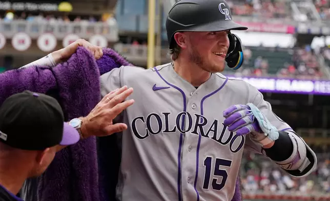 Colorado Rockies' Hunter Goodman celebrates his solo home run against the Minnesota Twins in the third inning of a baseball game Saturday, June 27, 2026, in Minneapolis. (AP Photo/Bruce Kluckhohn)