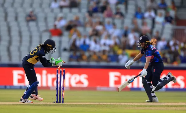 Scotland's Priyanaz Chatterji is ran out by Sri Lanka's Kaushini Nuthyangana during the ICC Women's T20 World Cup match at Emirates Old Trafford in Manchester, England, on Friday June 26, 2026. (Nigel French/PA via AP)